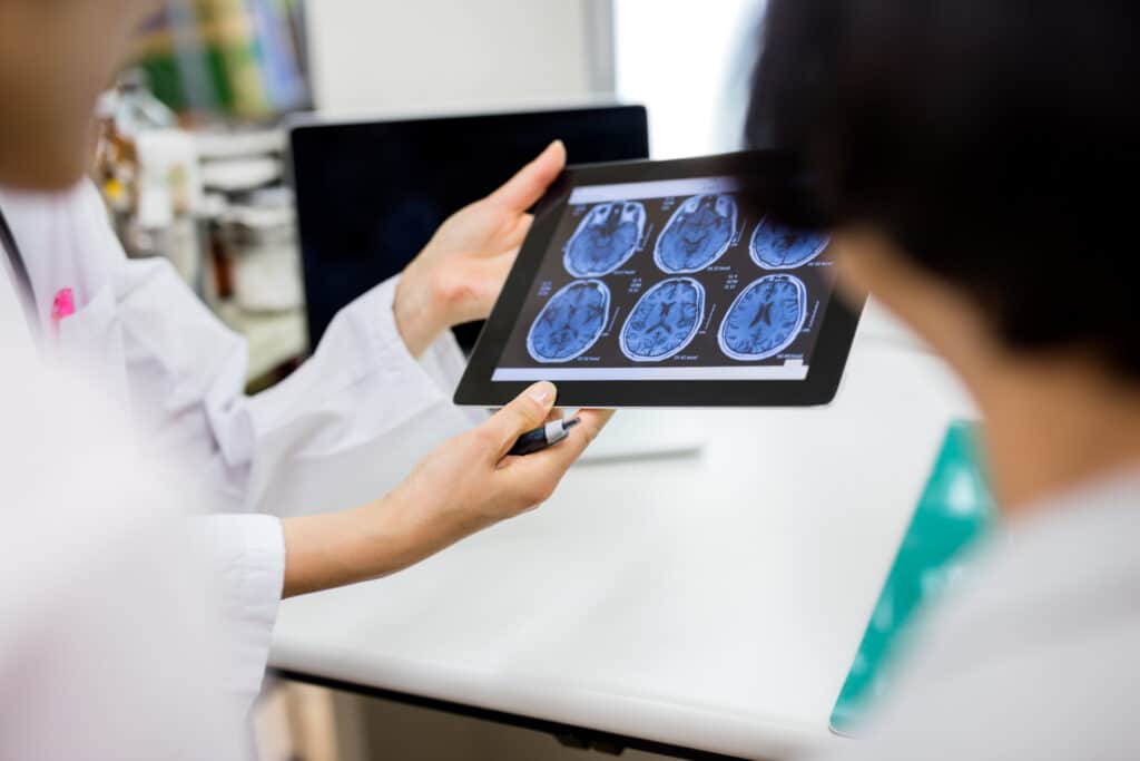 Doctor and patient using digital tablet in hospital