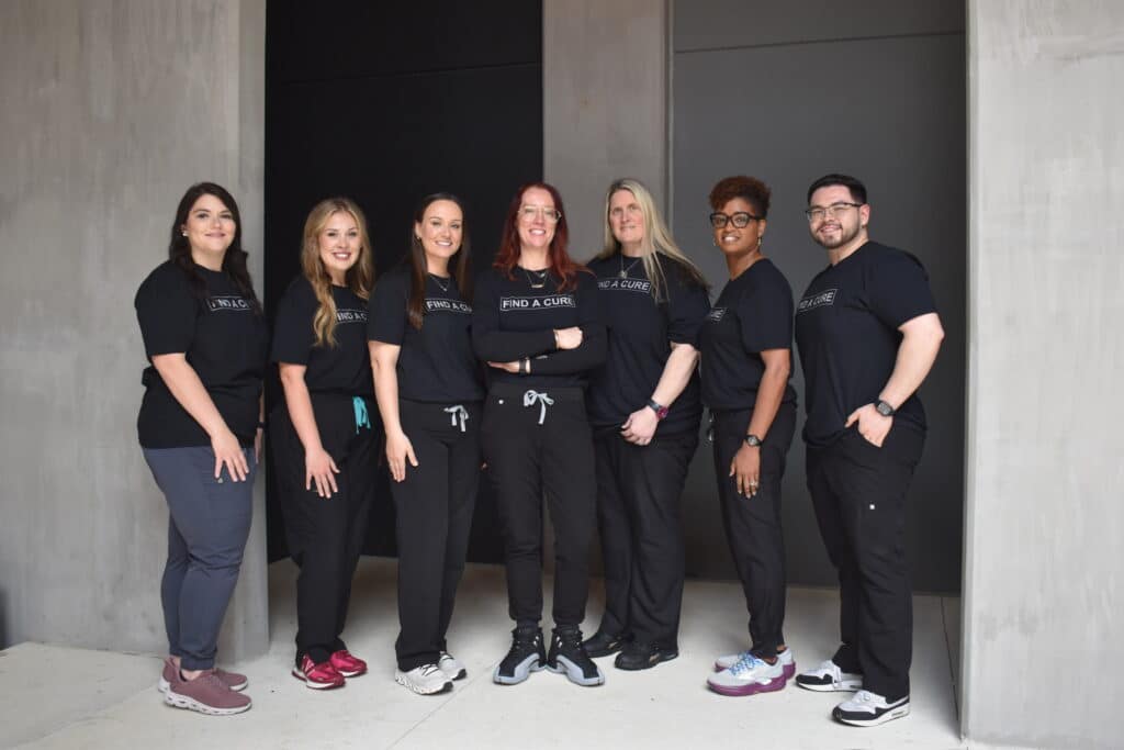 Southern Neurosurgery Team wearing black scrubs and t-shirts standing outside