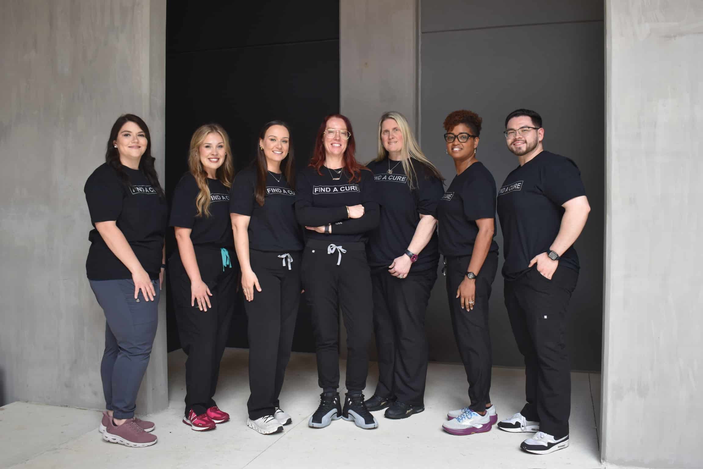 Southern Neurosurgery Team wearing black scrubs and t-shirts standing outside