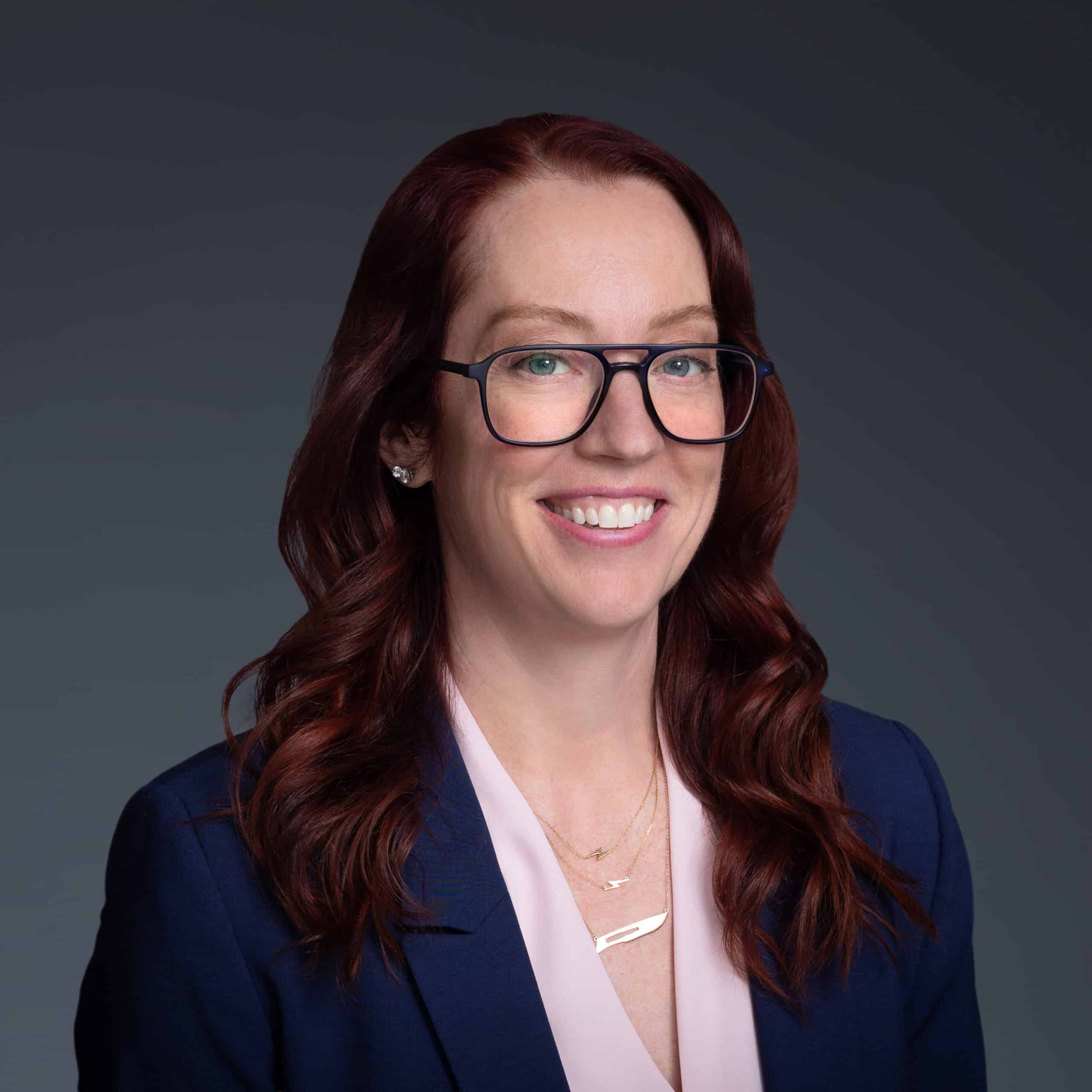 Headshot of Dr. Betsy Grunch wearing pink blouse and navy jacket