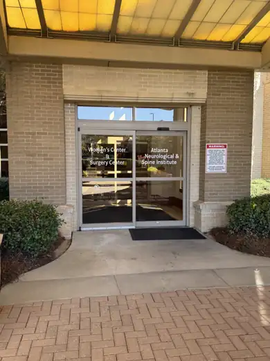 Glass doors marked Women’s Center & Surgery Center and Atlanta Neurological & Spine Institute at Southern Regional Medical Center